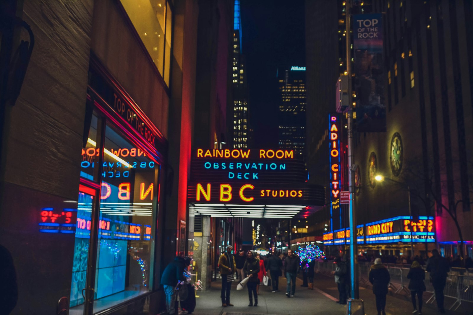 Broadcast studios and neon signage on a city street at night